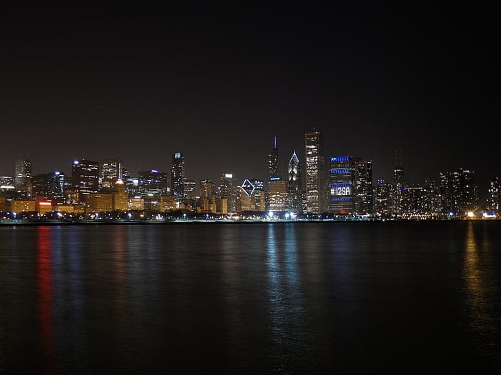 Chicago skyline glowing at golden hour over Lake Michigan